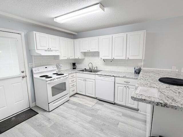 885 Santa Rosa Boulevard, Unit 111A Fort Walton Beach, FL 32548 - Photo 6 of 16 a kitchen with granite countertop white cabinets and white appliances