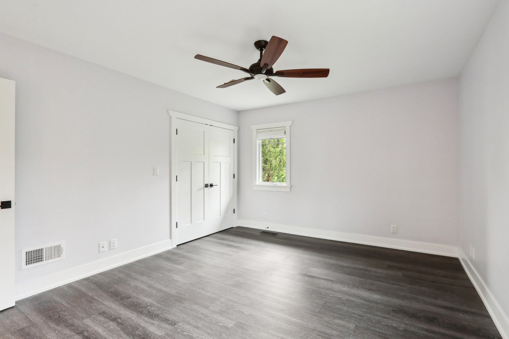 598 Rockefeller Road Lake Forest, IL 60045 - Photo 37 of 86 an empty room with wooden floor a ceiling fan and windows