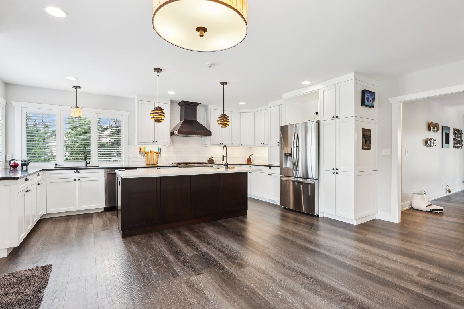598 Rockefeller Road Lake Forest, IL 60045 - Photo 9 of 86 a large kitchen with stainless steel appliances kitchen island granite countertop a refrigerator a sink dishwasher a stove and white countertops with wooden floor
