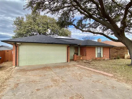 a view of a house with a yard and garage