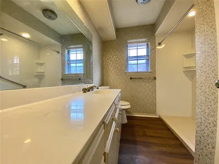 a bathroom with a tub sink and mirror
