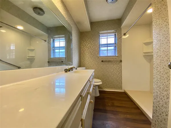 a bathroom with a tub sink and mirror