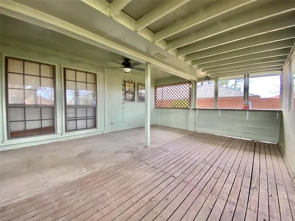 a view of a room with wooden floor