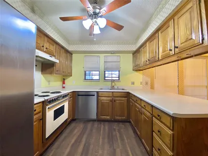 a kitchen with stainless steel appliances granite countertop a stove and a sink