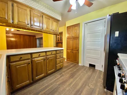 a kitchen with stainless steel appliances granite countertop a refrigerator and a stove top oven