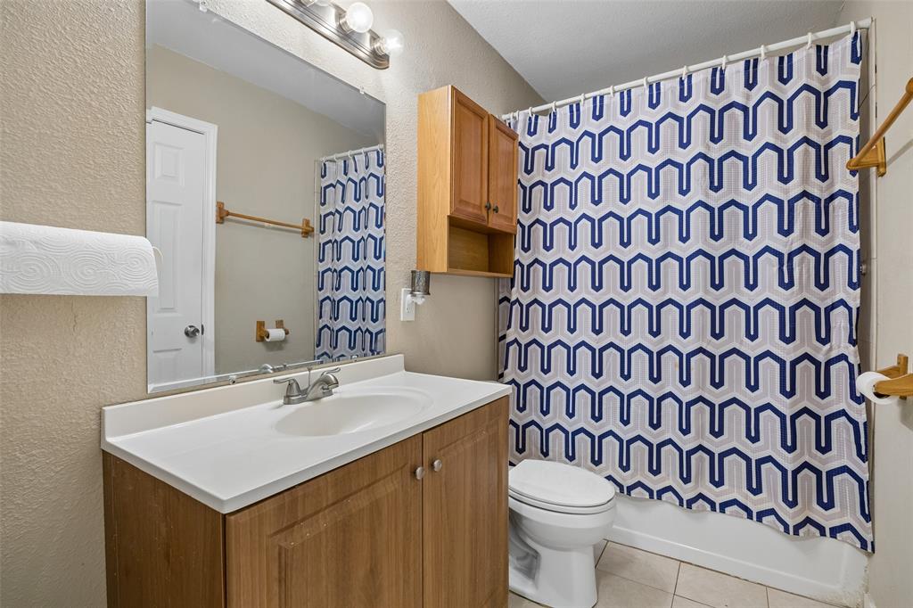 117 Moon Street Cleburne, TX 76033 - Photo 23 of 28 a bathroom with a sink and a toilet