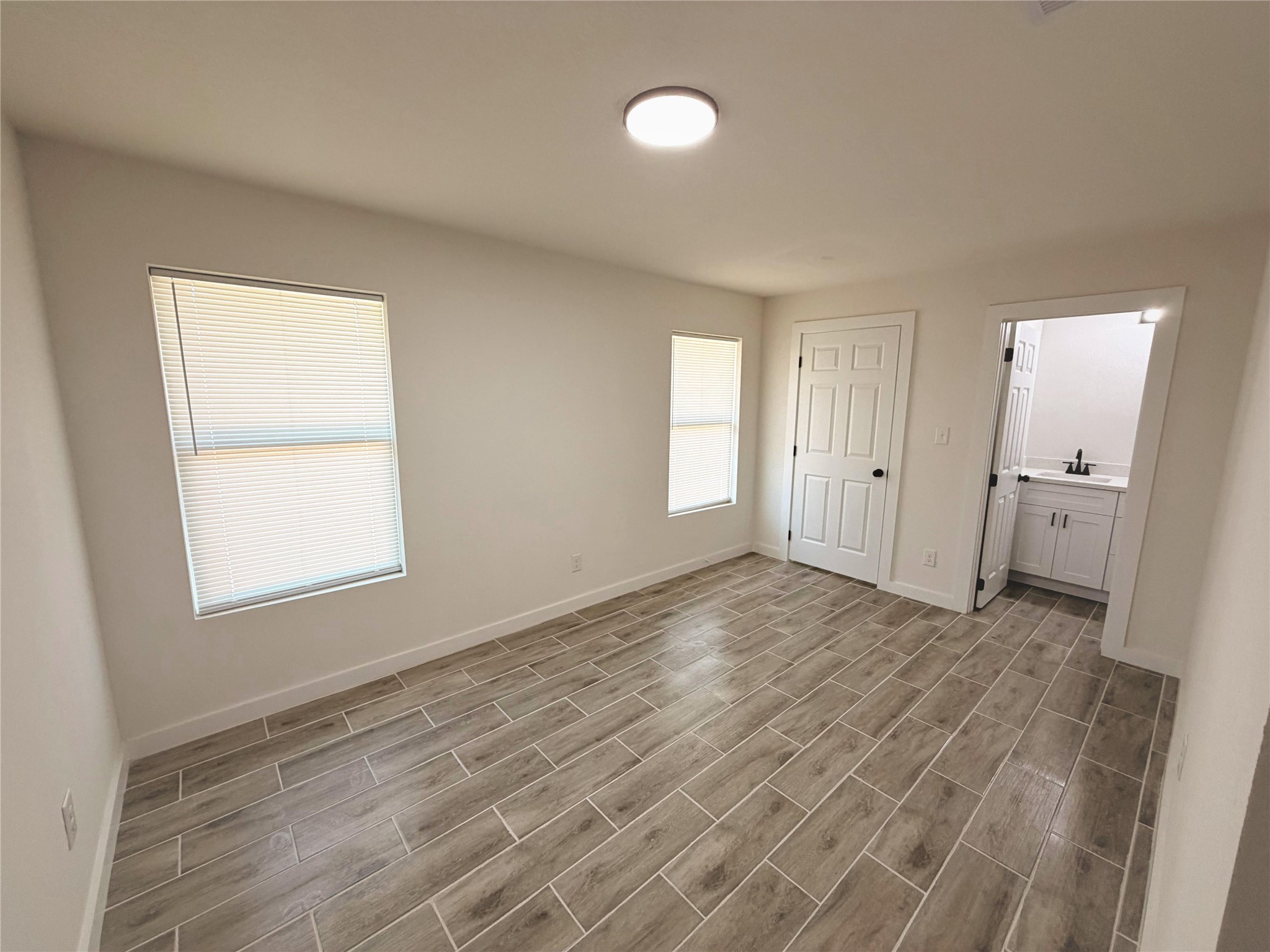 5842 Beldart Street Houston, TX 77033 - Photo 12 of 24 a view of empty room with window and wooden floor