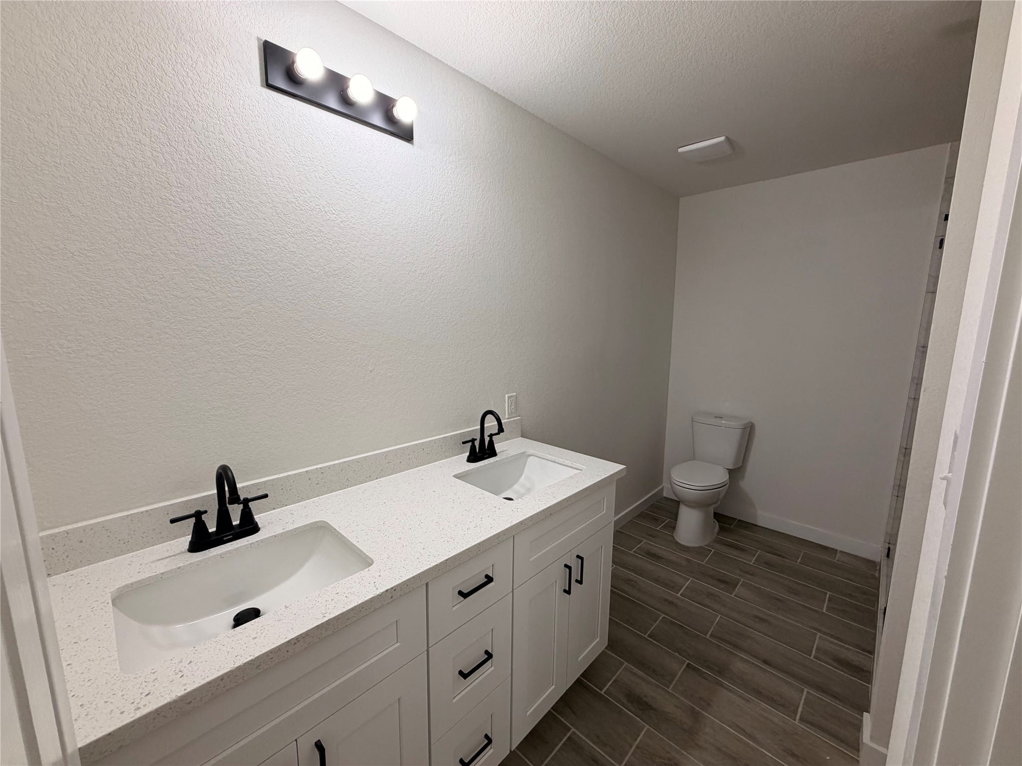 5842 Beldart Street Houston, TX 77033 - Photo 13 of 24 a bathroom with a sink and a mirror
