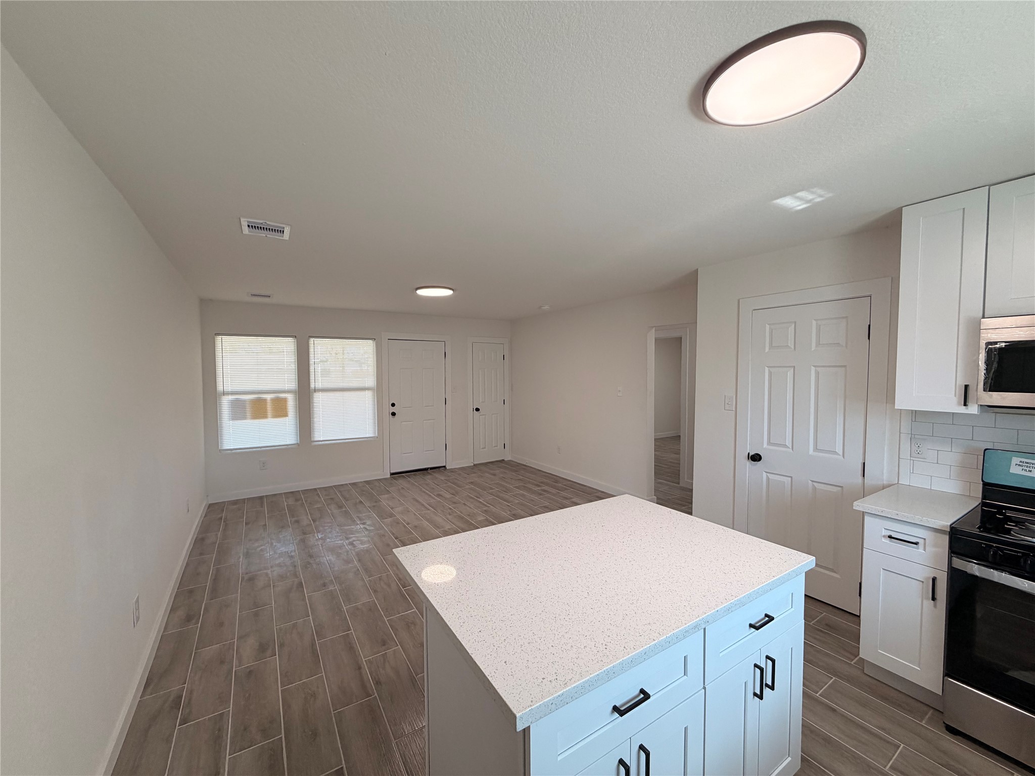 5842 Beldart Street Houston, TX 77033 - Photo 18 of 24 a kitchen with cabinets appliances and a window