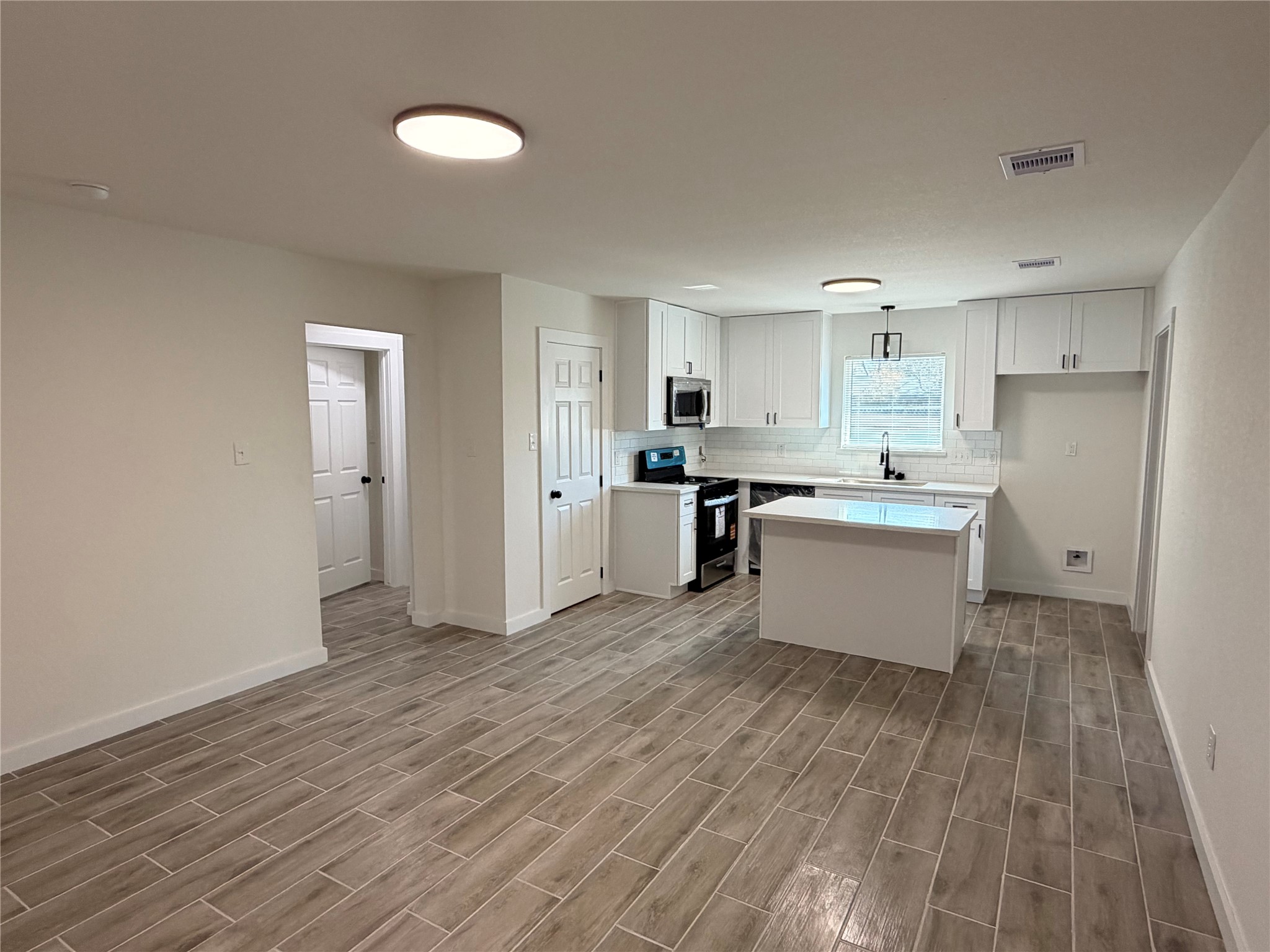 5842 Beldart Street Houston, TX 77033 - Photo 2 of 24 a view of a kitchen with wooden floor