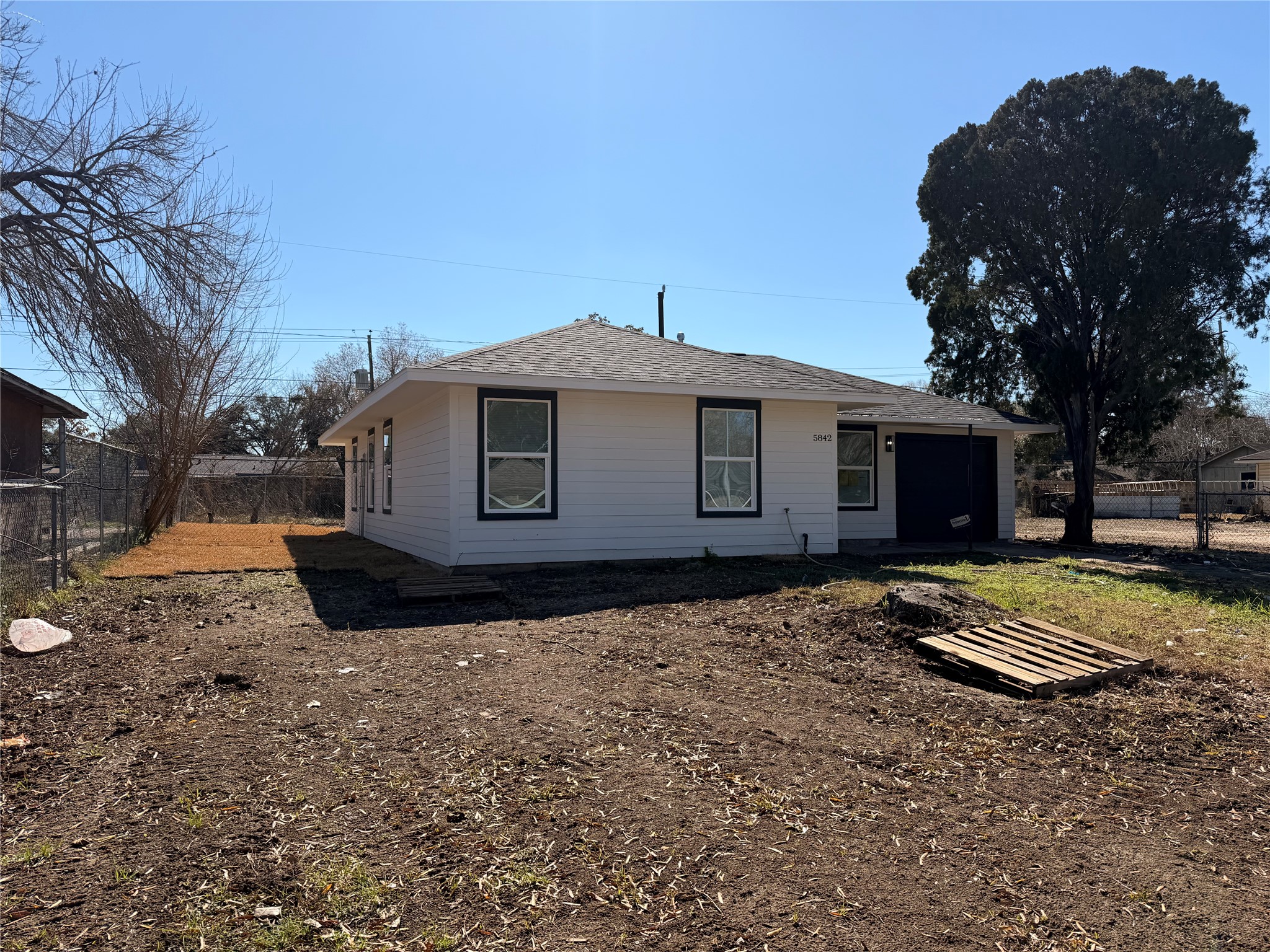 5842 Beldart Street Houston, TX 77033 - Photo 23 of 24 a front view of a house with a yard