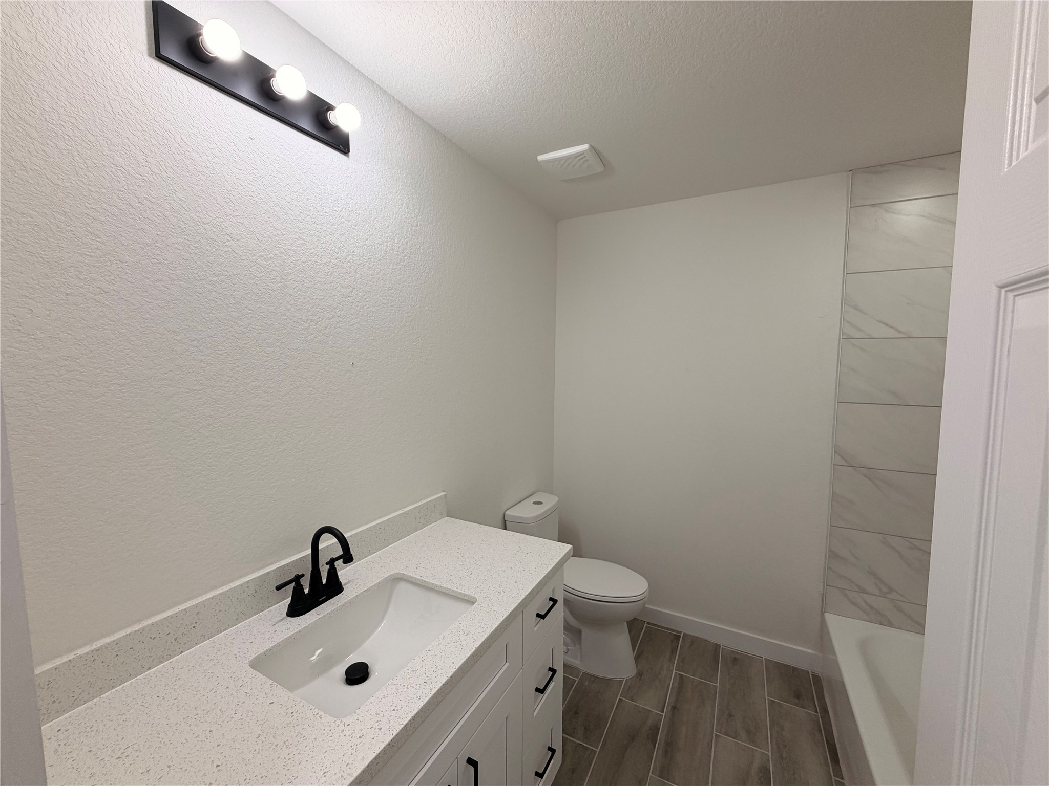 5842 Beldart Street Houston, TX 77033 - Photo 7 of 24 a bathroom with a sink and a toilet