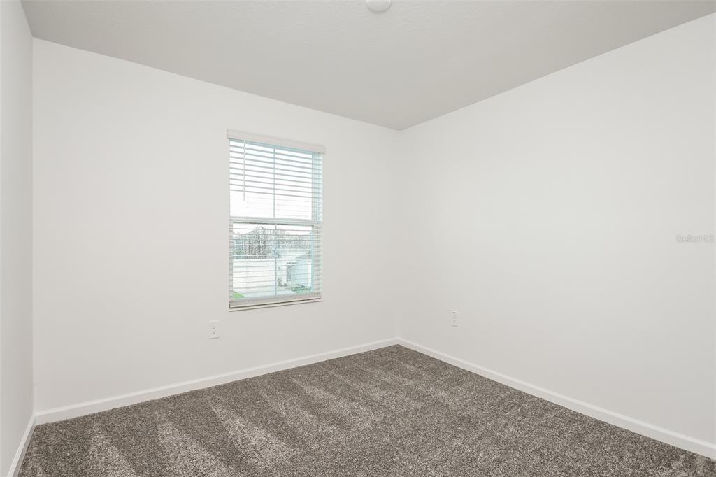 256 Hayley Street Lake Wales, FL 33859 - Photo 11 of 15 an empty room with a window