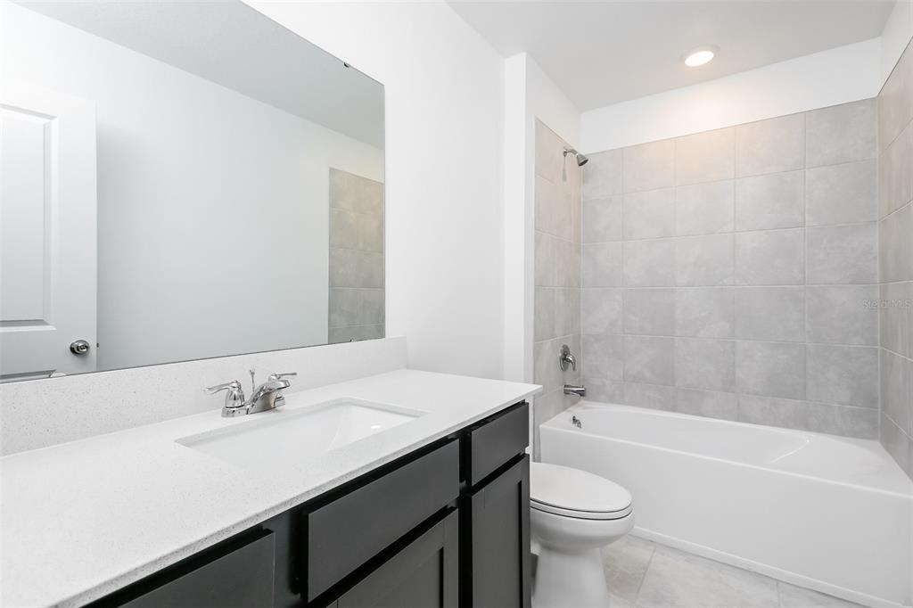 256 Hayley Street Lake Wales, FL 33859 - Photo 14 of 15 a bathroom with a sink a toilet and a bathtub
