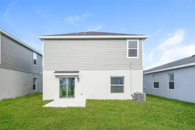 a view of a house with a backyard