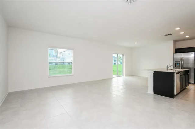 an empty room with windows and natural light