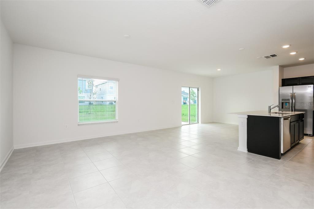 256 Hayley Street Lake Wales, FL 33859 - Photo 3 of 15 an empty room with windows and natural light