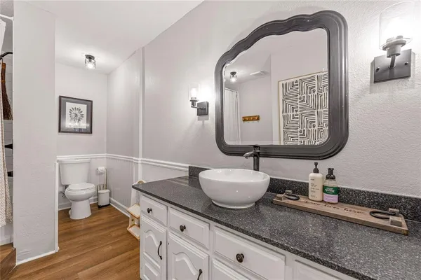 a bathroom with a shower a toilet and a sink