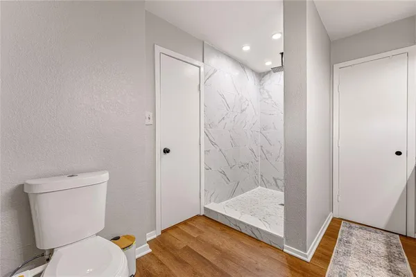 a bathroom with a toilet and a shower