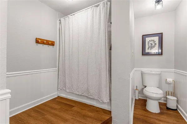 a bedroom with furniture and a wooden floor