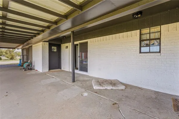 a building outdoor space with patio furniture and a potted plant