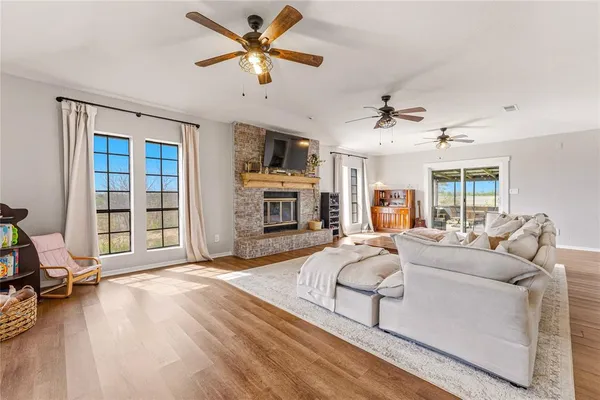 a living room with furniture a fireplace and a flat screen tv