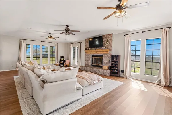 a living room with fireplace furniture and a wooden floor