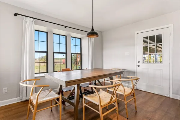 a view of a kitchen with a table and chairs