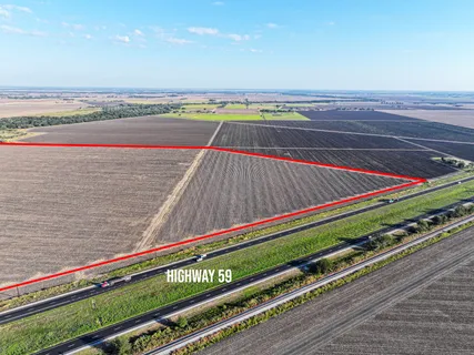 a view of a tennis ground with a wooden bridge