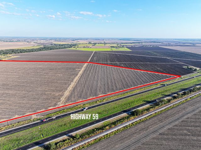 a view of a tennis ground with a wooden bridge