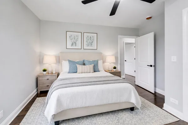 a bedroom with a bed and a night stand