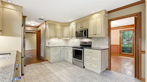 a kitchen with white cabinets and white appliances