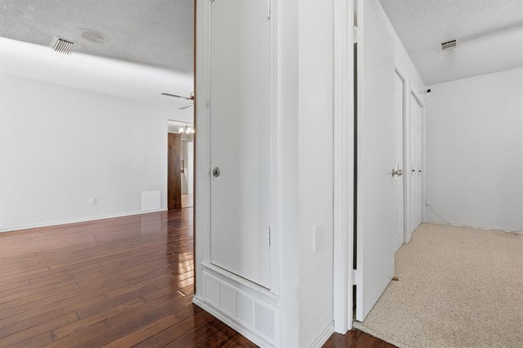 1817 Indian School Road Garland, TX 75044 - Photo 15 of 40 Corridor with a textured ceiling and dark wood-type flooring