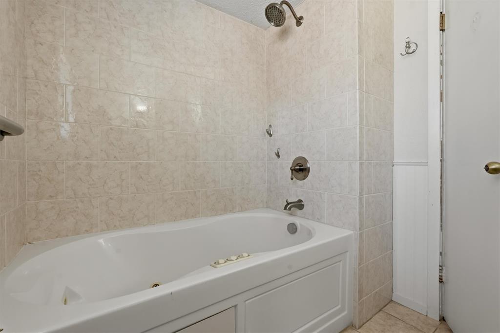 1817 Indian School Road Garland, TX 75044 - Photo 22 of 40 Full bathroom with shower / washtub combination and light tile patterned flooring