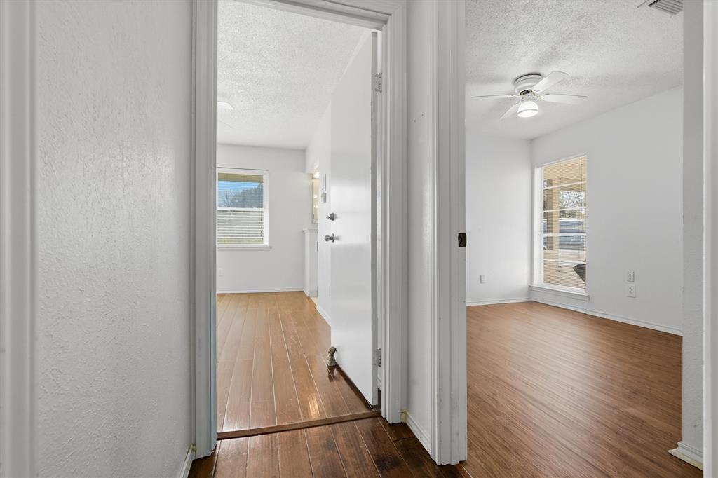 1817 Indian School Road Garland, TX 75044 - Photo 24 of 40 Corridor with a textured ceiling and dark wood-style flooring