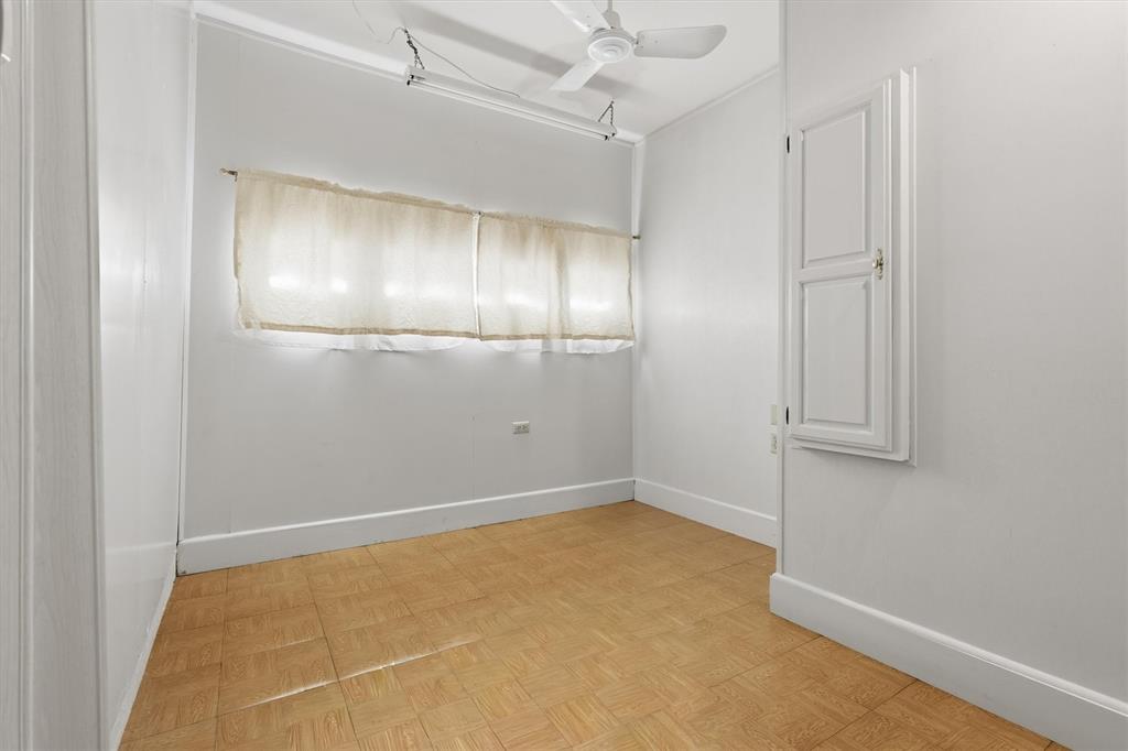 1817 Indian School Road Garland, TX 75044 - Photo 30 of 40 Unfurnished room featuring a ceiling fan and baseboards