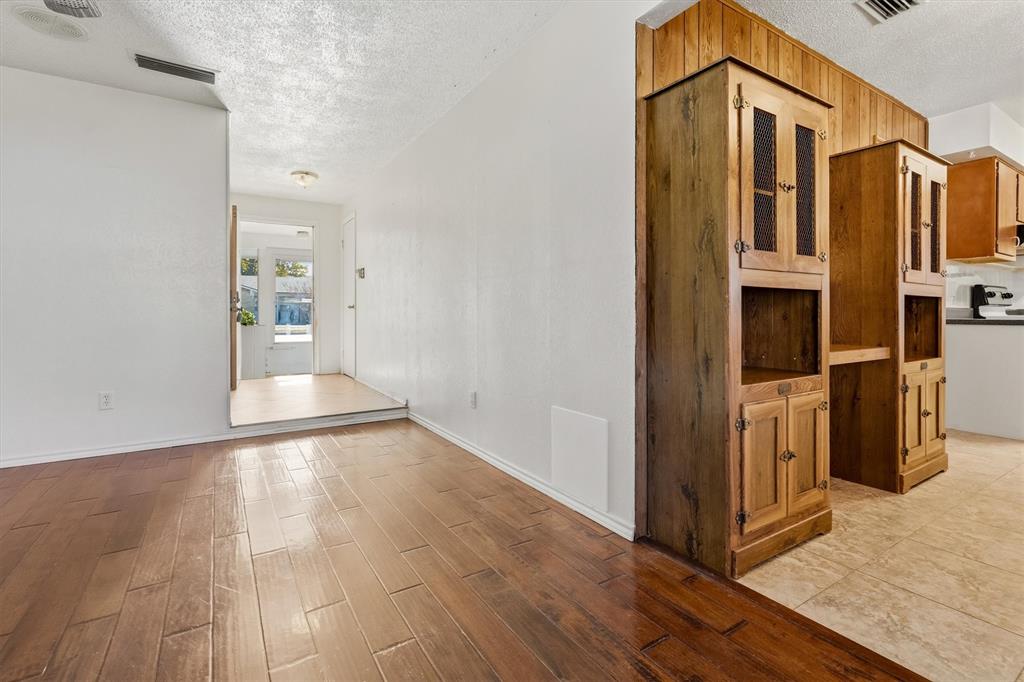 1817 Indian School Road Garland, TX 75044 - Photo 3 of 40 Hallway with a textured ceiling and light wood-type flooring