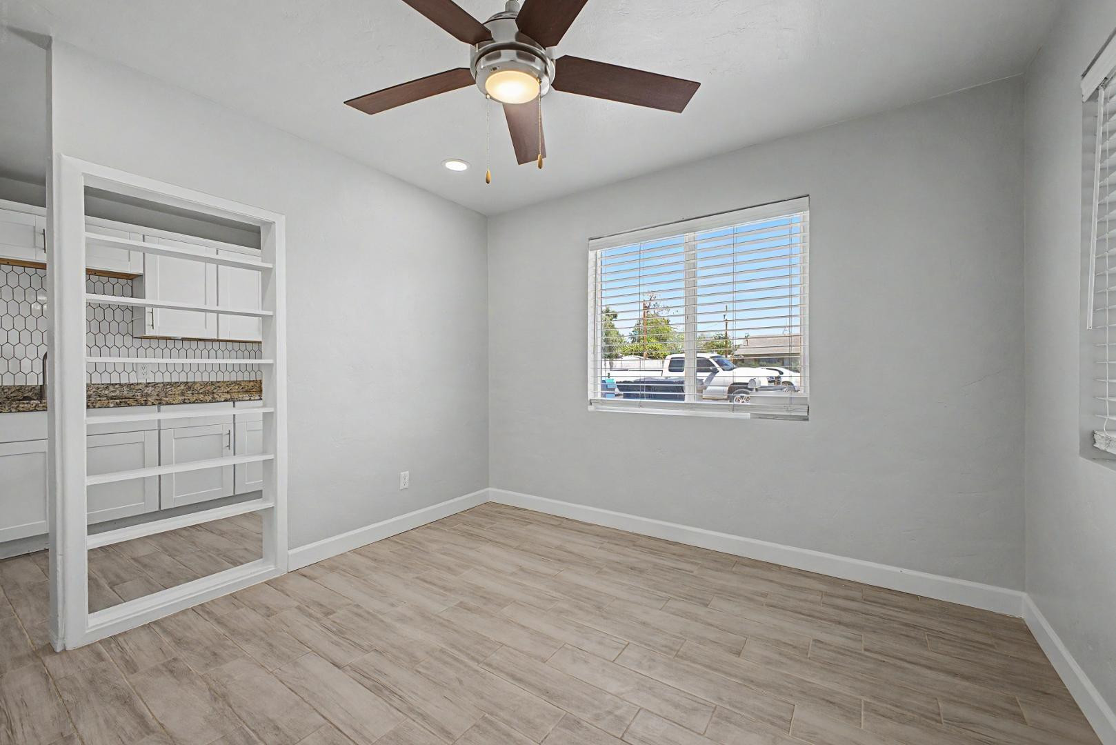 2534 North 28th Street Phoenix, AZ 85008 - Photo 11 of 33 a view of an empty room with a window and wooden floor