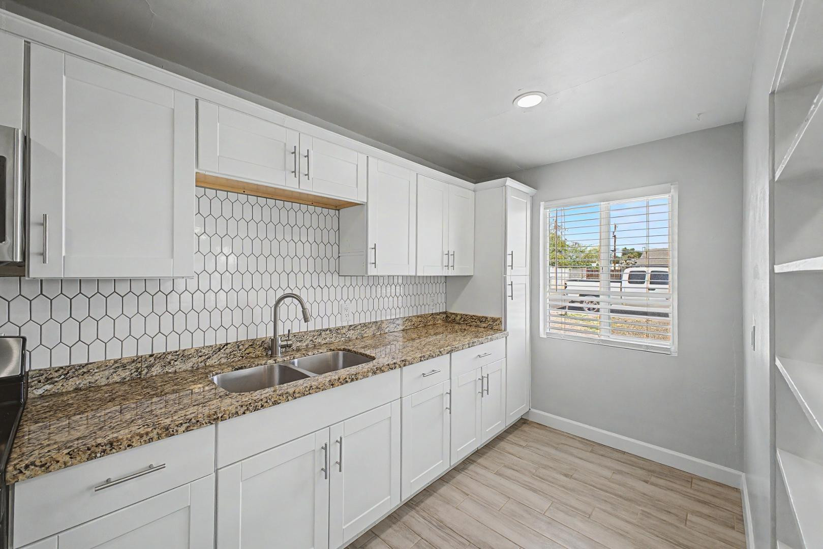 2534 North 28th Street Phoenix, AZ 85008 - Photo 12 of 33 a kitchen with a sink cabinets and window