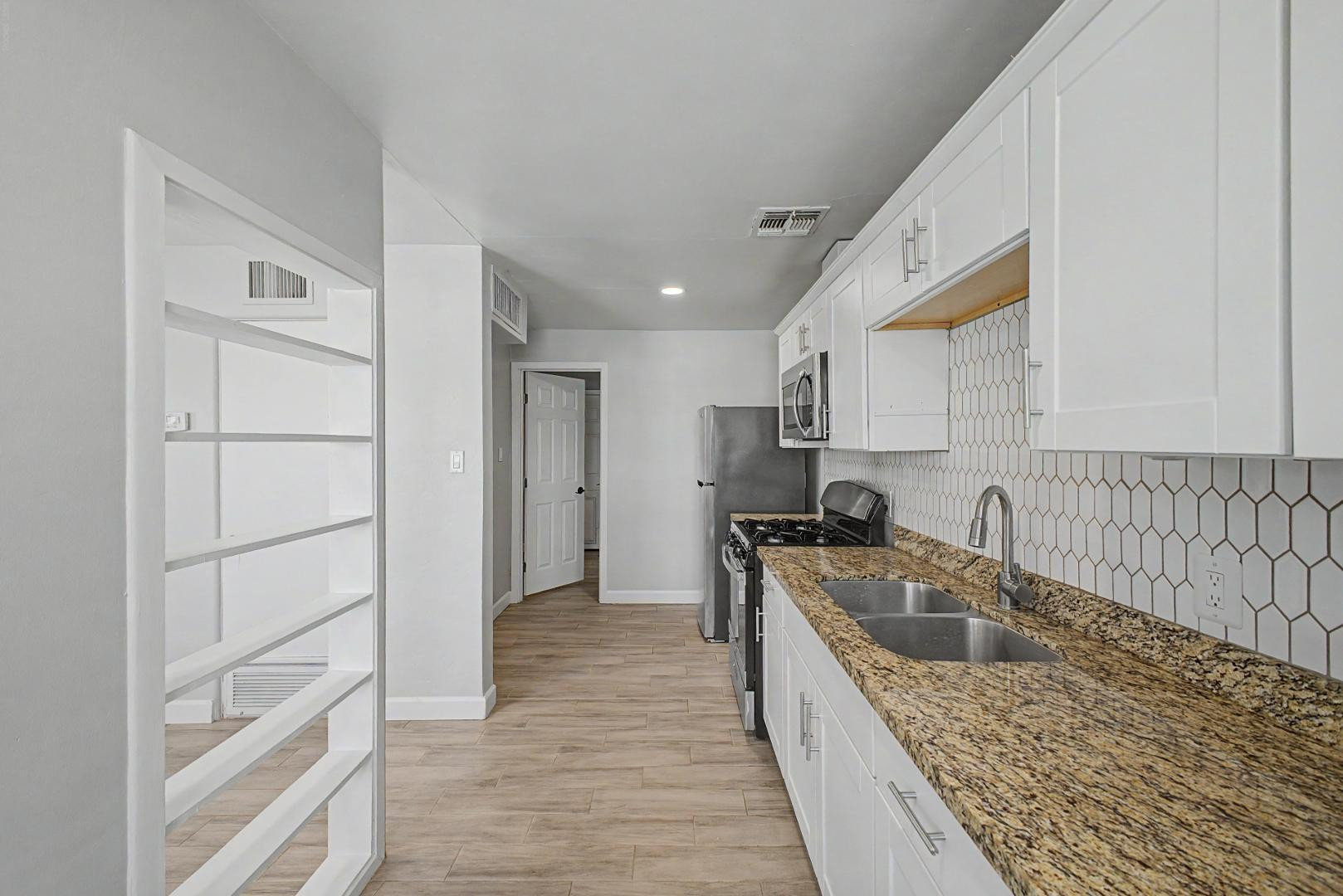 2534 North 28th Street Phoenix, AZ 85008 - Photo 13 of 33 a kitchen that has a sink and a stove in it