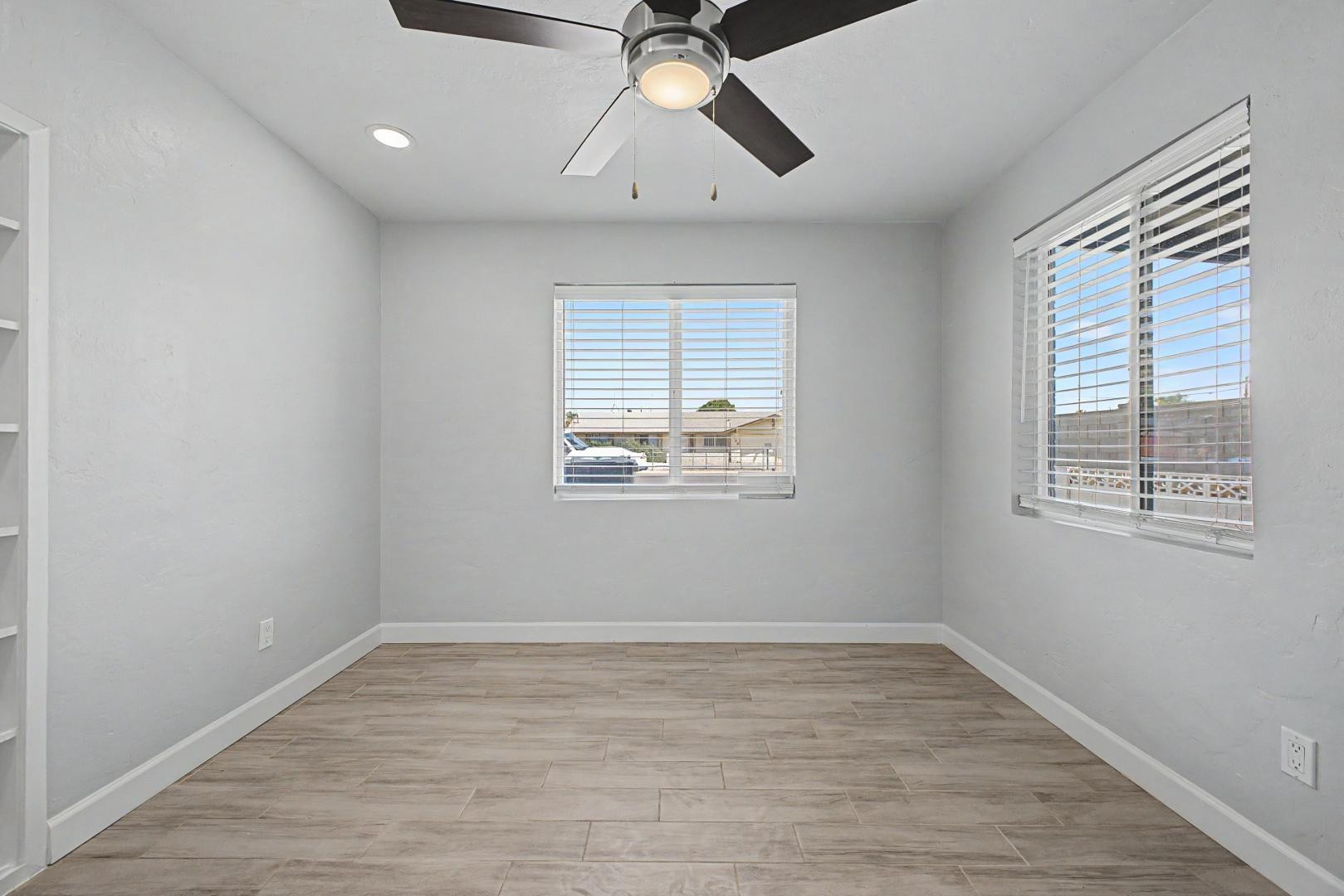 2534 North 28th Street Phoenix, AZ 85008 - Photo 19 of 33 a view of empty room with wooden floor and fan