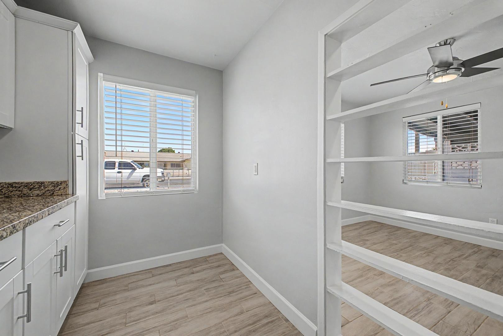 2534 North 28th Street Phoenix, AZ 85008 - Photo 10 of 33 a view of walk in closet with wooden floor and window