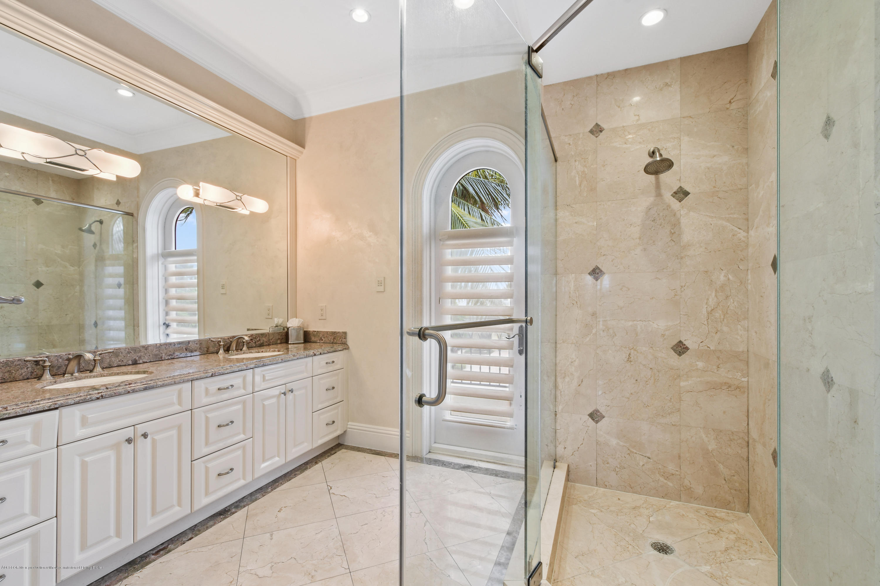 777 Northeast 35th Street Boca Raton, FL 33431 - Photo 37 of 50 a spacious bathroom with a shower a sink and a mirror