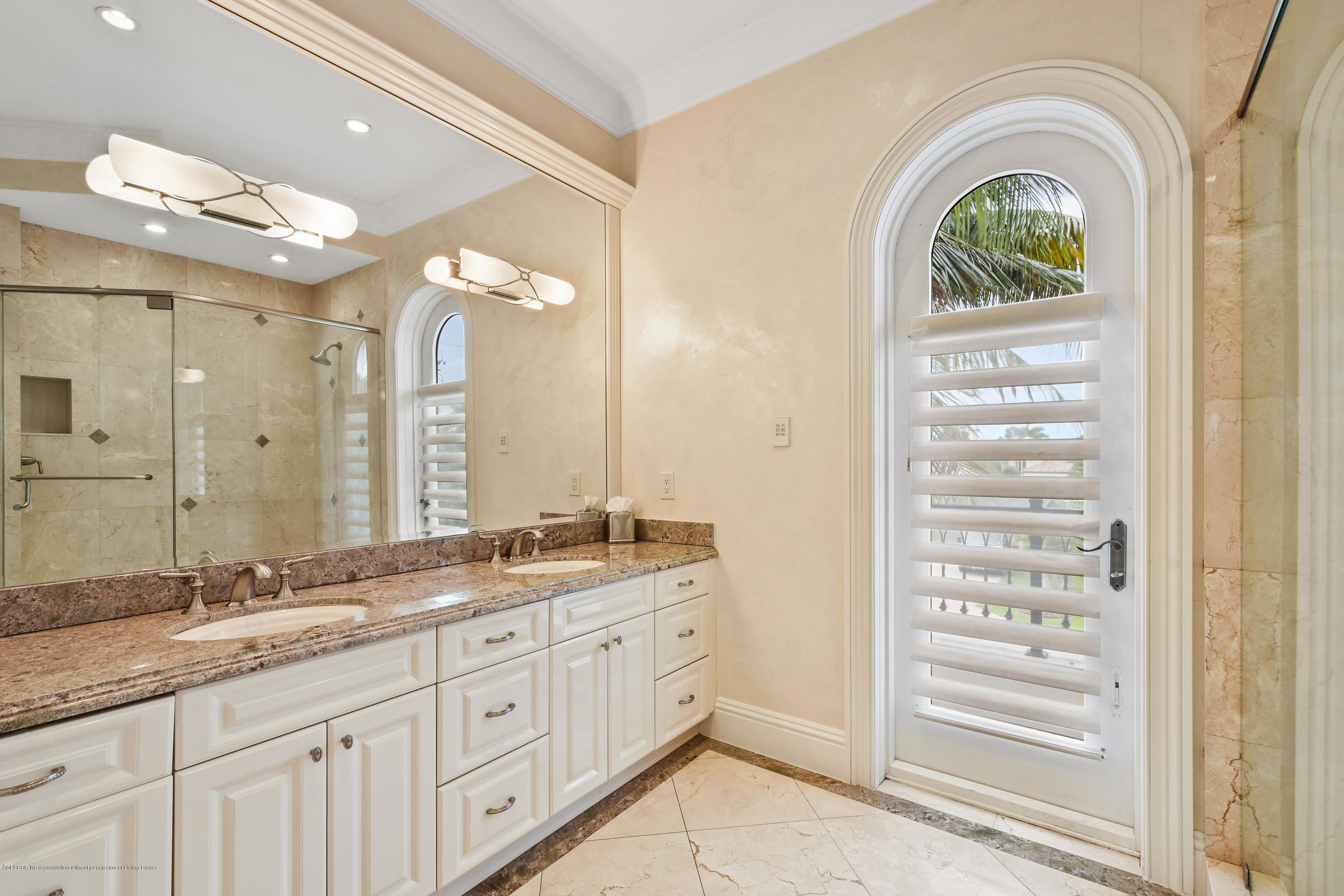 777 Northeast 35th Street Boca Raton, FL 33431 - Photo 38 of 50 a bathroom with a granite countertop sink a mirror and a shower
