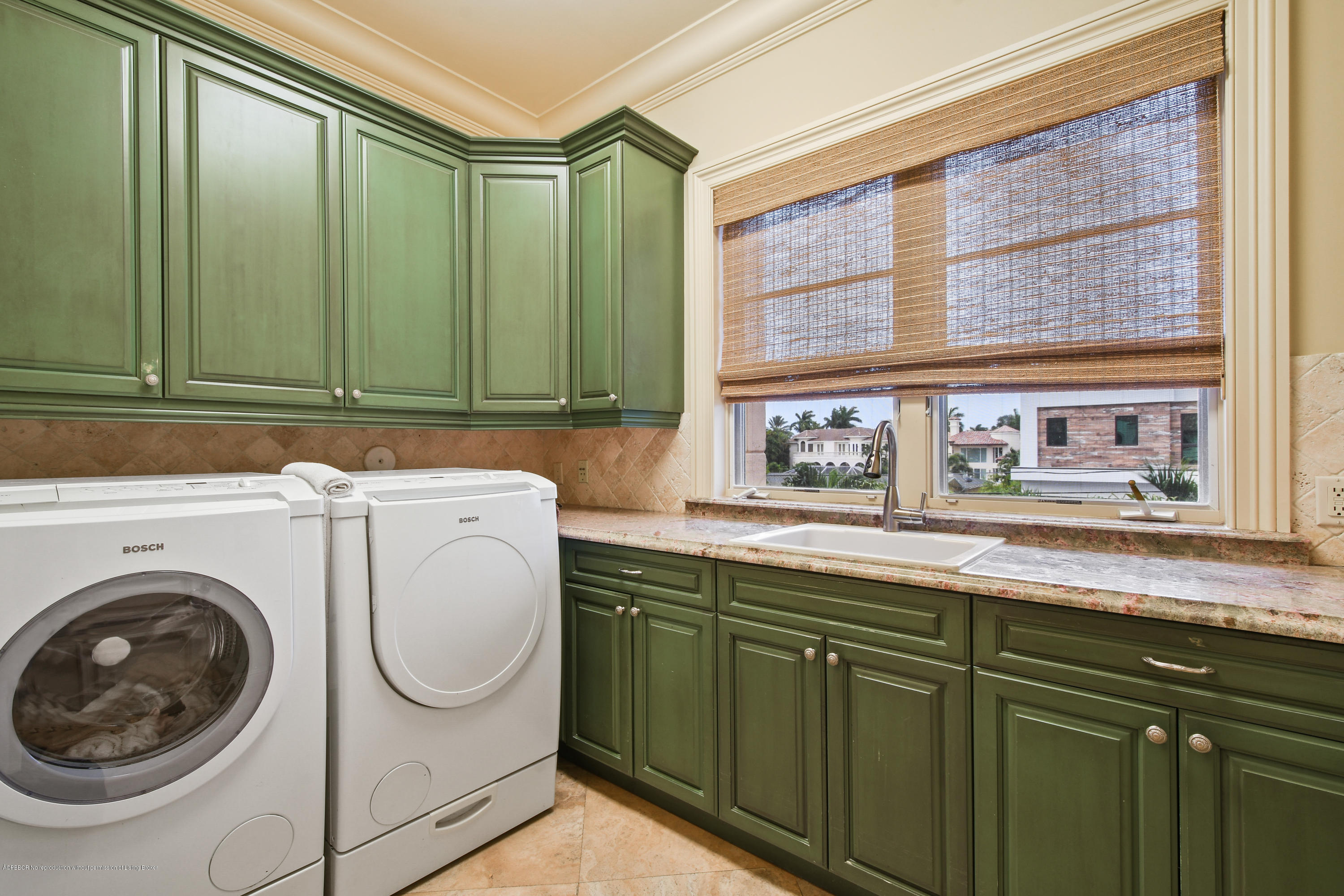 777 Northeast 35th Street Boca Raton, FL 33431 - Photo 43 of 50 a utility room with stainless steel appliances white cabinets and a sink