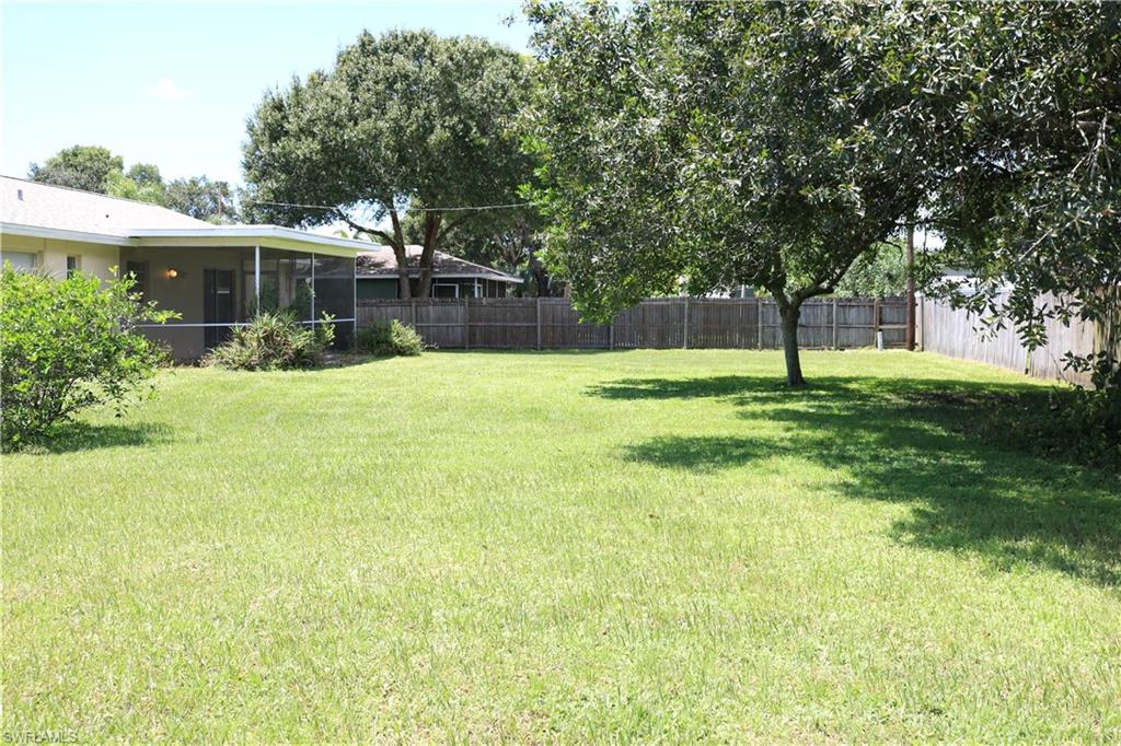 19177 Acorn Road Fort Myers, FL 33967 - Photo 23 of 24 a backyard of a house with plants and large tree