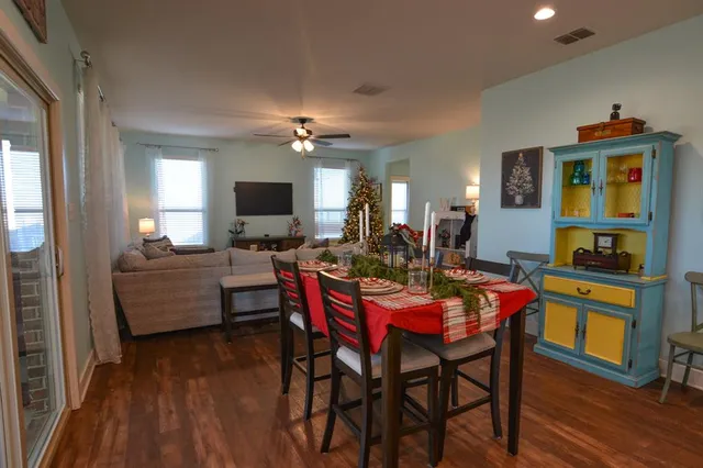 a view of a dining room with furniture and wooden floor