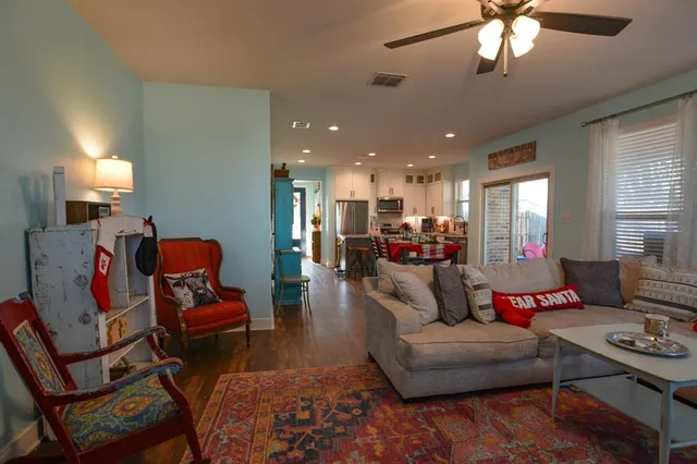 a living room with furniture and a chandelier