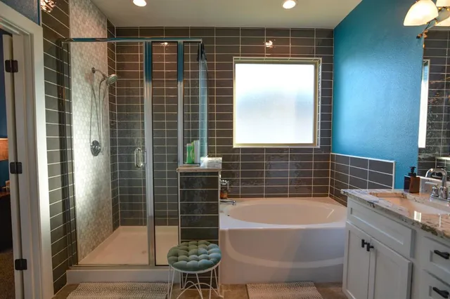 a bathroom with a bathtub and a shower
