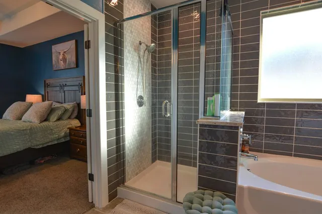 a bathroom with a bathtub and a shower